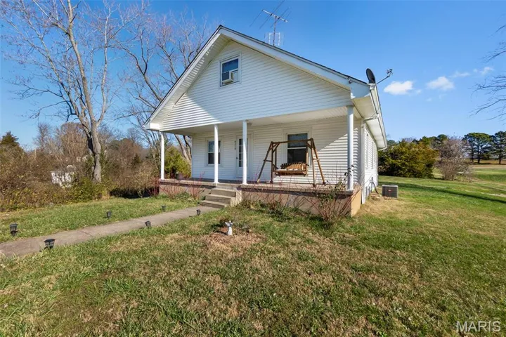 Bungalow with a porch and a front yard