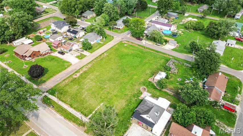 Aerial view of property's location featuring nearby suburban area