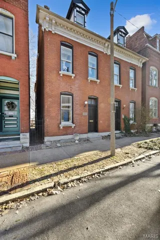 View of front of home featuring brick siding