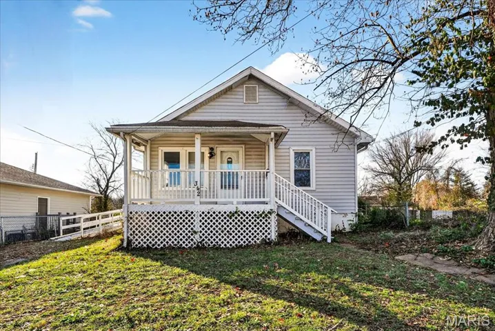 Bungalow-style house with a porch and stairway