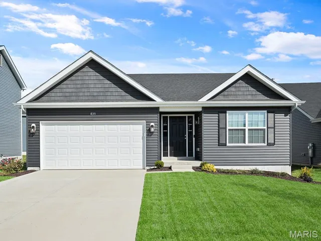 Ranch-style house with a garage, concrete driveway, a front lawn, and a shingled roof