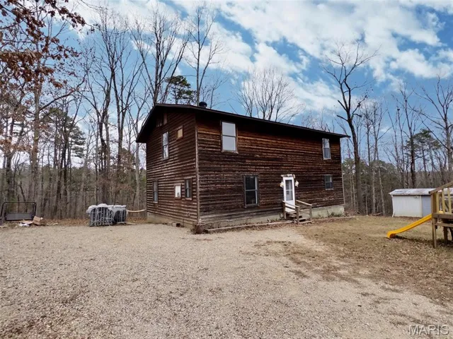 View of home's exterior featuring an outbuilding