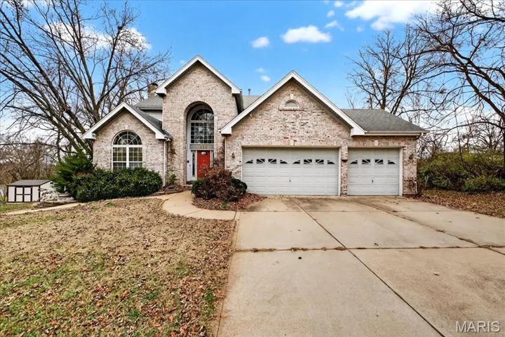 Facade showing 3 car garage.
