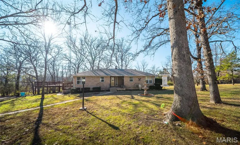 Rear view of house with a yard