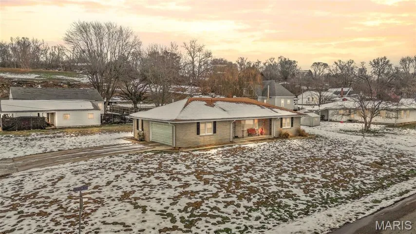 View of front of house with driveway and an attached garage