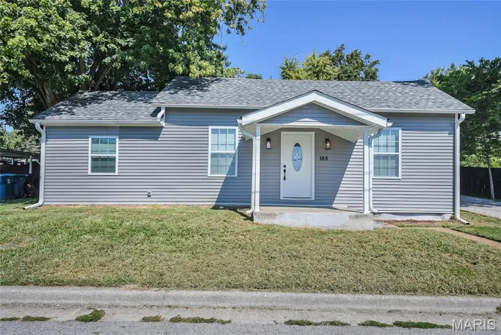Bungalow-style house with a porch, a front lawn, and roof with shingles