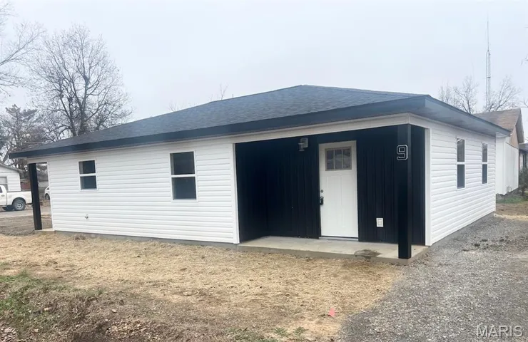 Back of house with a shingled roof