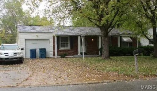 Ranch-style home featuring a garage and covered porch