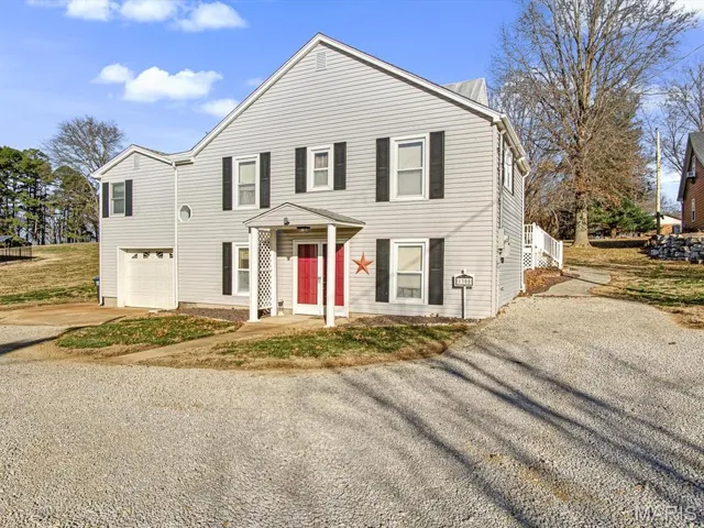 View of front of property with driveway and a garage