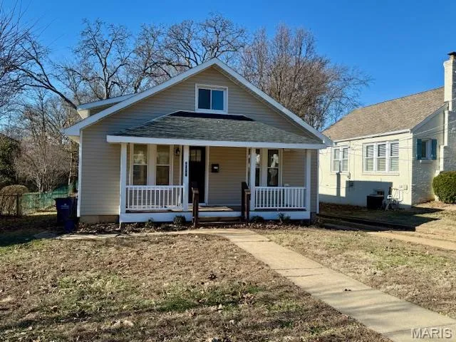 Bungalow-style house with a porch and roof with shingles