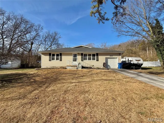 Single story home with asphalt driveway, a garage, and a front yard
