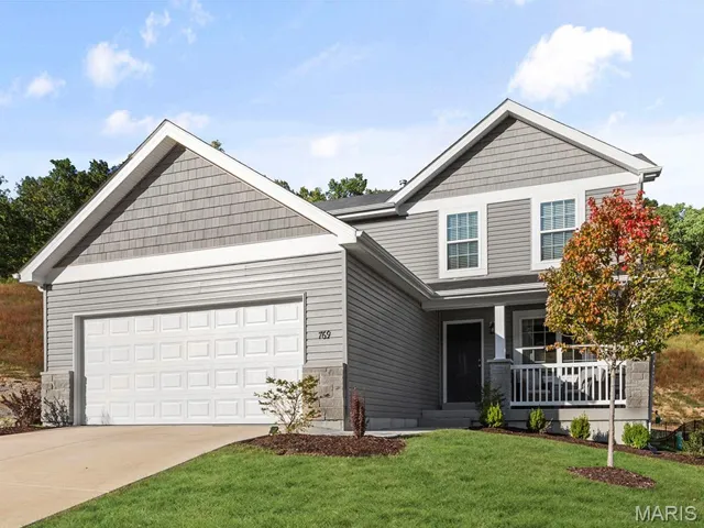 Craftsman house with a porch, concrete driveway, an attached garage, and a front lawn
