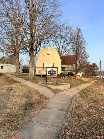 Front view from corner lot of cottages with a sign.
