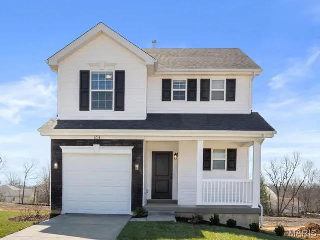 View of front facade with a porch, roof with shingles, an attached garage, driveway, and a front lawn