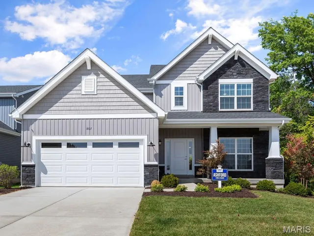 Craftsman inspired home with a porch, a garage, and a front lawn