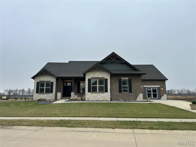 Craftsman house featuring a porch, a front lawn, stone siding, and roof with shingles