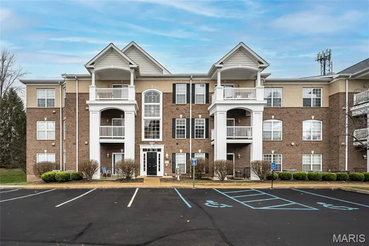 View of property with uncovered parking