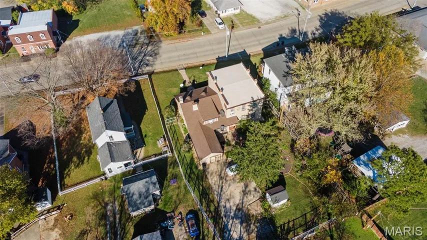 Aerial view of property's location with nearby suburban area
