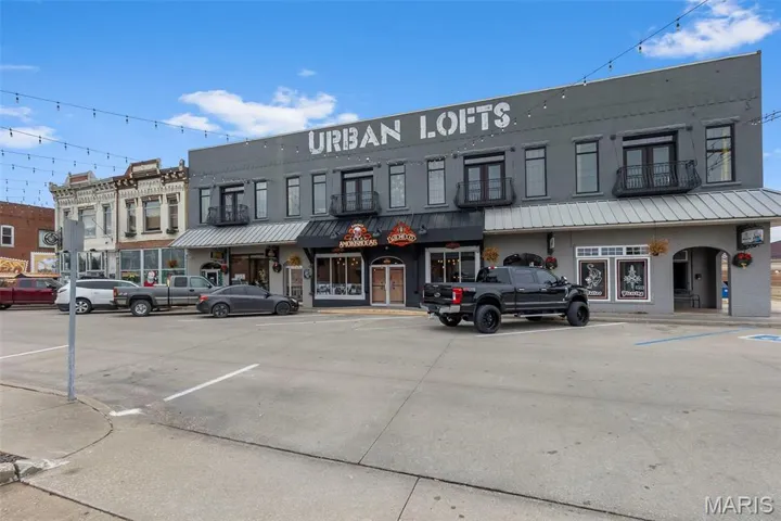 View of commercial property with uncovered parking
