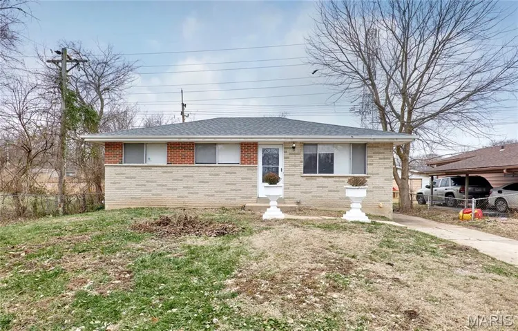 View of front of home with brick siding and roof with shingles