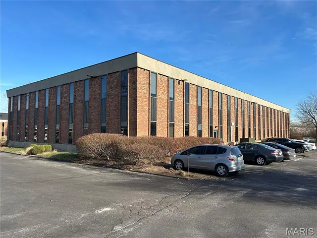 View of property with uncovered parking
