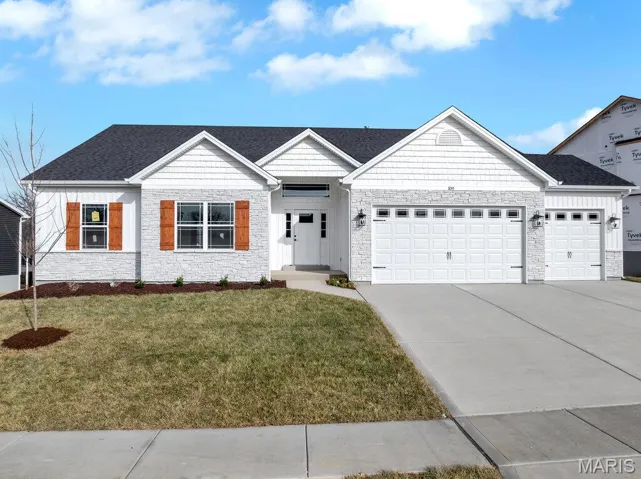 View of front of house featuring stone siding, concrete driveway, a front lawn, an attached garage, and a shingled roof