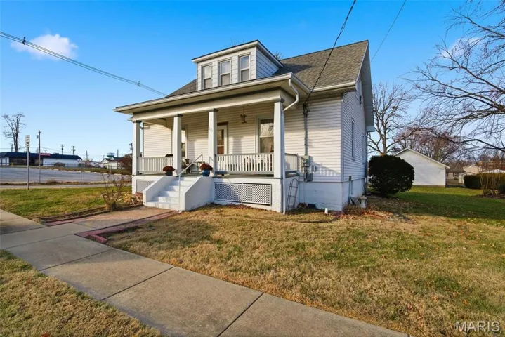 Bungalow-style home with a porch, a shingled roof, and a front lawn