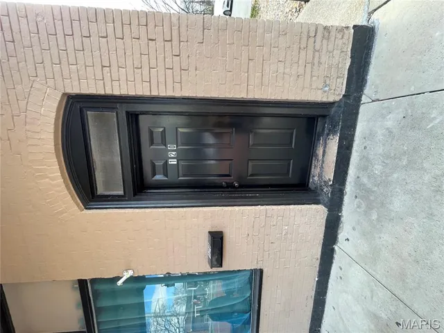 Entrance to property with brick siding