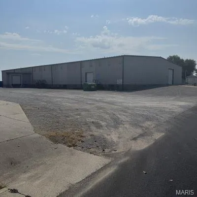 View of building exterior featuring an outbuilding