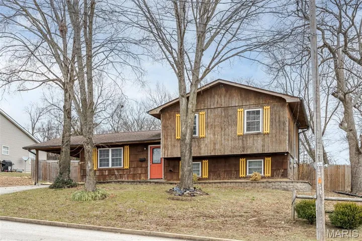 Split level home with an attached carport and driveway
