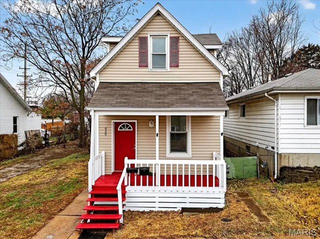 Bungalow-style house featuring a shingled roof and covered porch