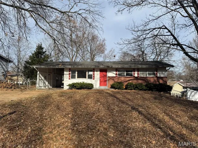 Ranch-style home with brick siding and an attached carport