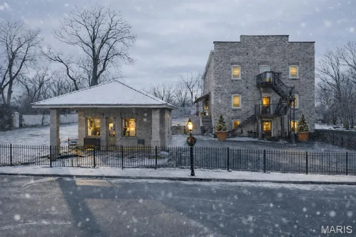 View of front of house featuring a fenced front yard and stairway