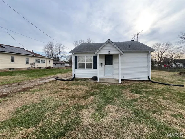 Bungalow-style house featuring a front yard and roof with shingles