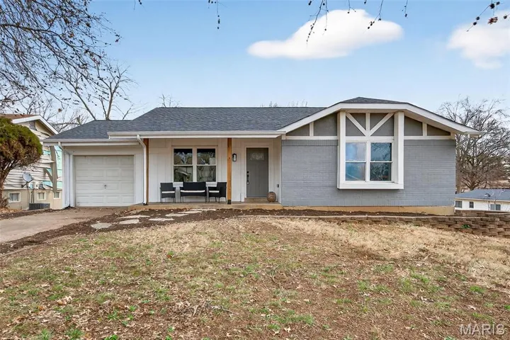Ranch-style house with a porch, a shingled roof, brick siding, driveway, and an attached garage