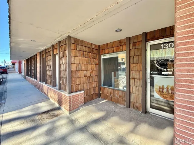 View of exterior entry with a porch