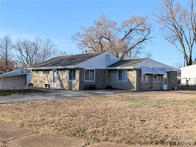 Single story home with a front yard and brick siding