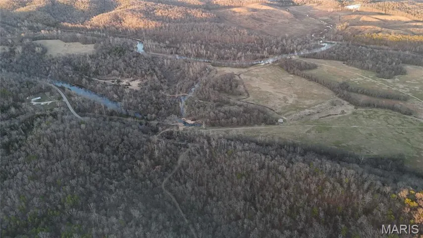 Aerial overview of property's location featuring a heavily wooded area