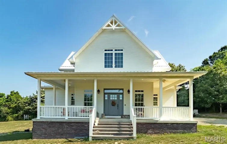 Farmhouse inspired home featuring covered porch