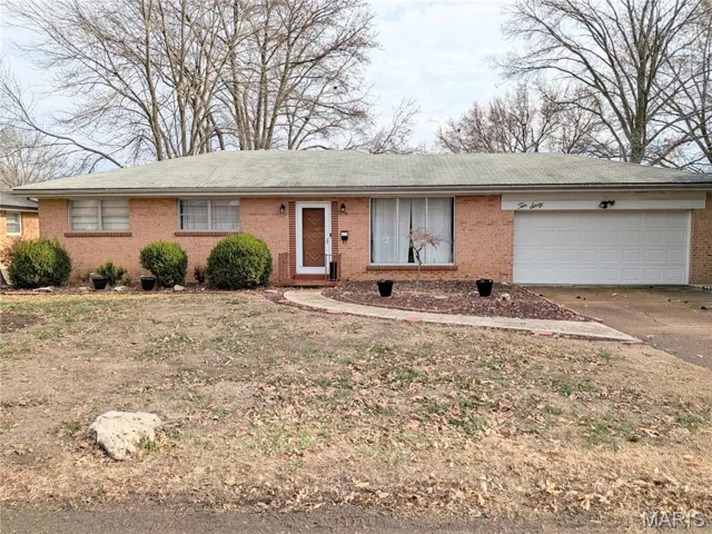 Single story home featuring brick siding, concrete driveway, a garage, and roof with shingles