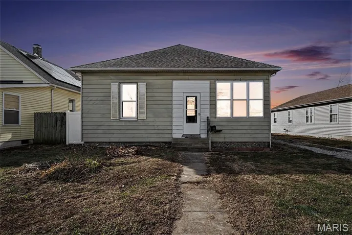 View of front of property featuring a shingled roof