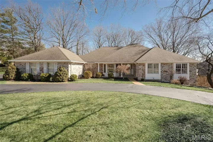 All brick ranch with circular driveway to host all your guests
