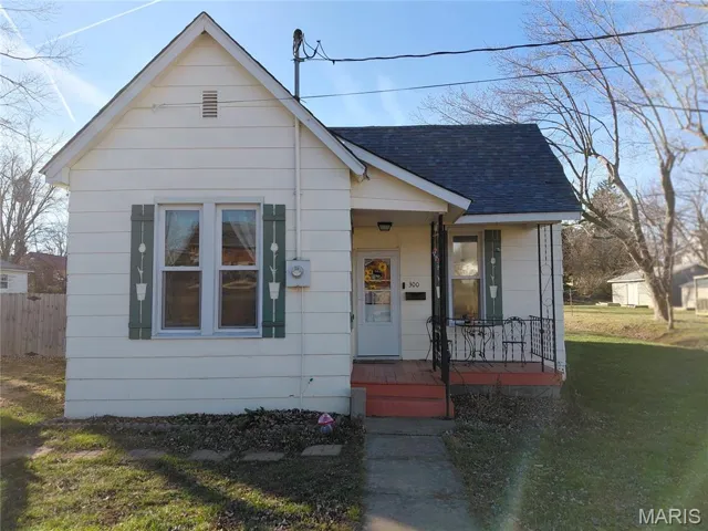 Bungalow-style house featuring a shingled roof and covered porch