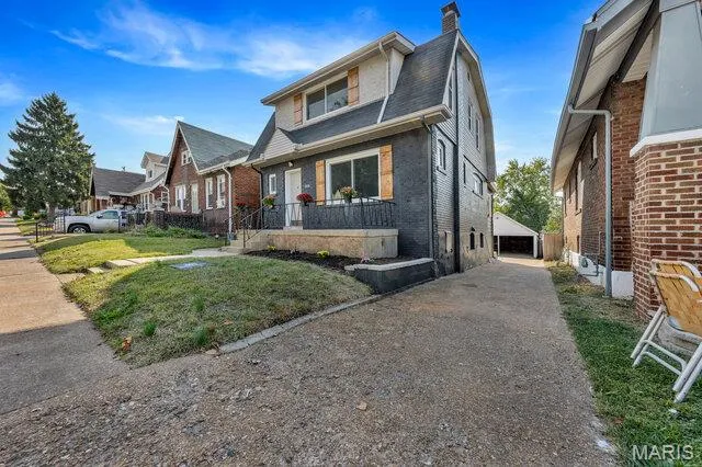 Bungalow featuring brick siding and a chimney