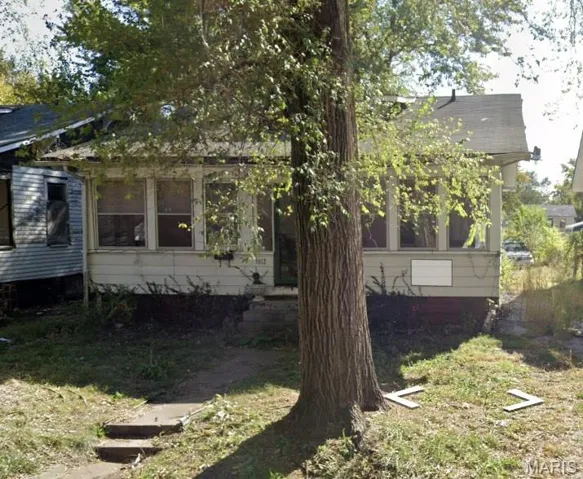 View of front of property with a sunroom