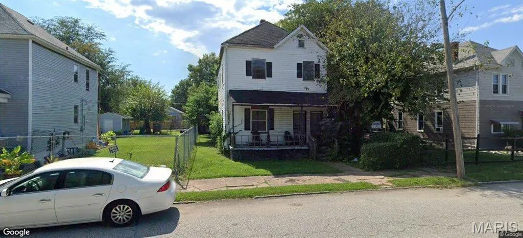 Traditional home featuring a porch and a residential view