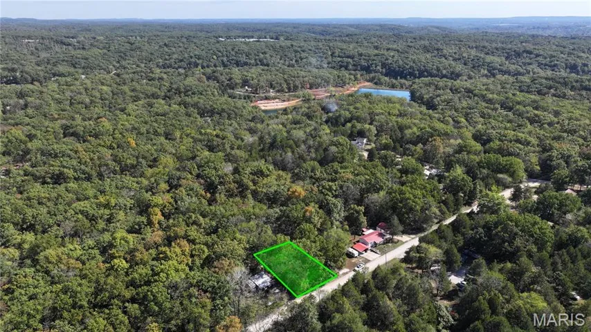Aerial overview of property's location featuring property parcel outlined and a large body of water
