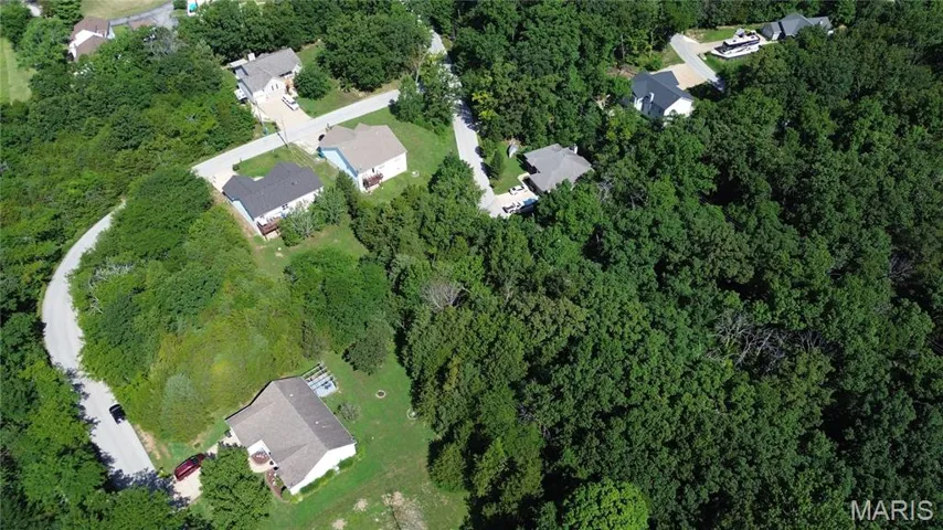 Aerial view of property's location featuring nearby suburban area