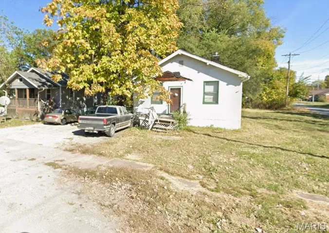 Bungalow-style house with a front lawn