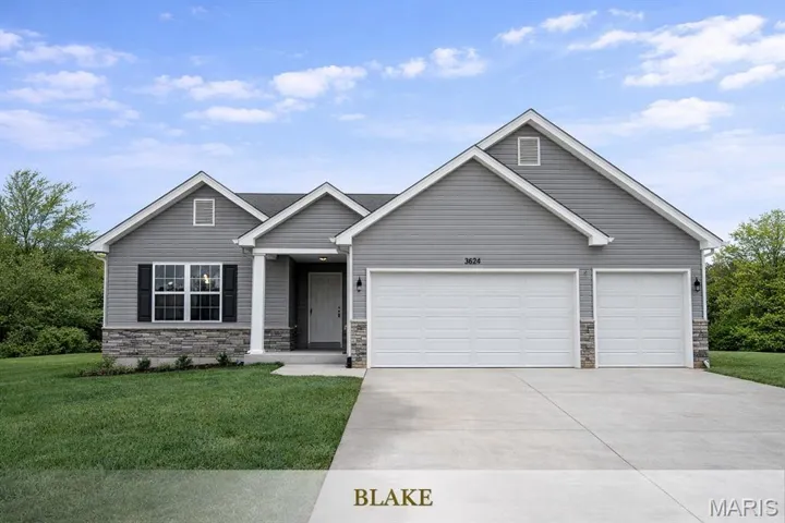 View of front facade with stone siding, driveway, a front yard, and an attached garage